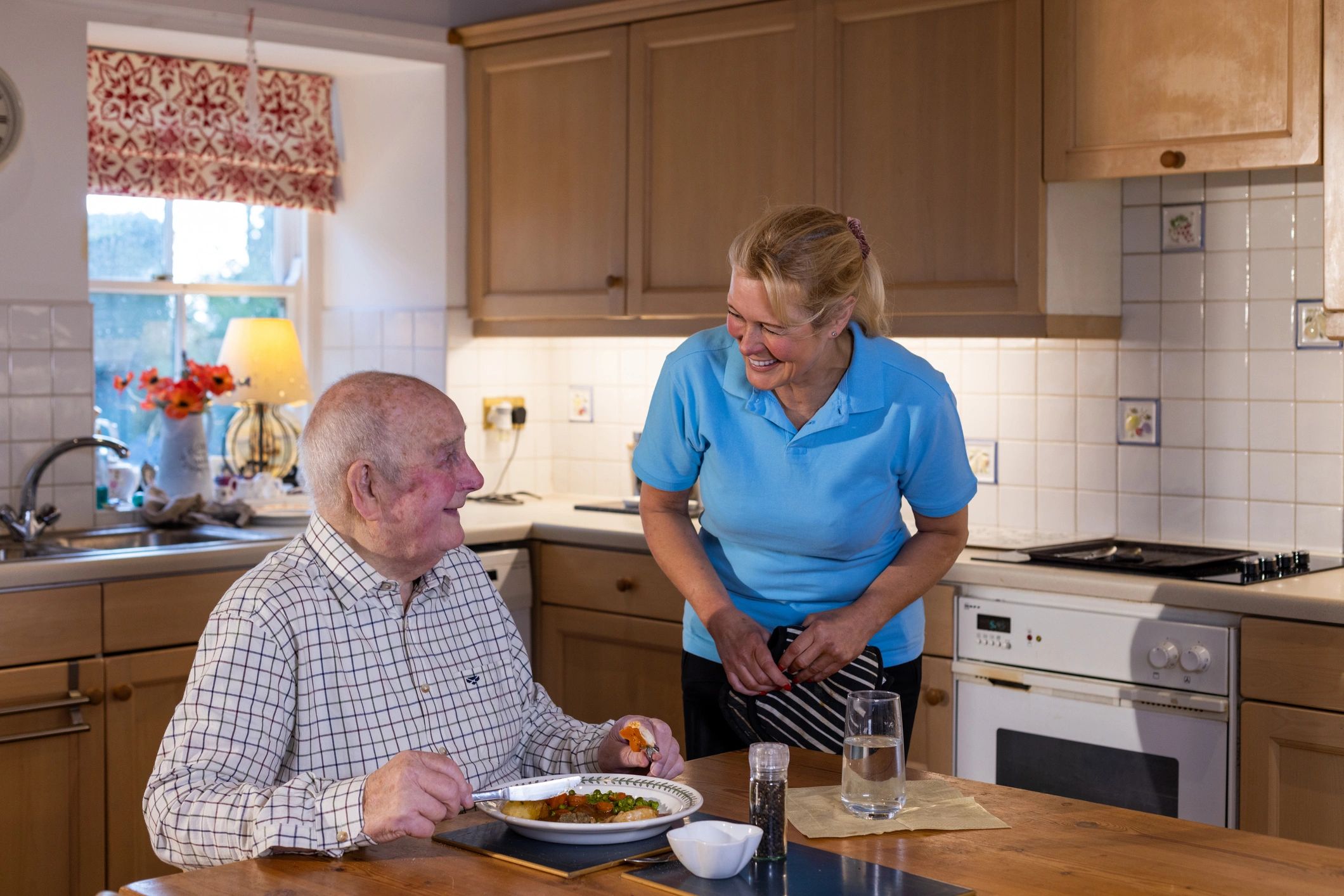 Caregiver serving a senior man at home