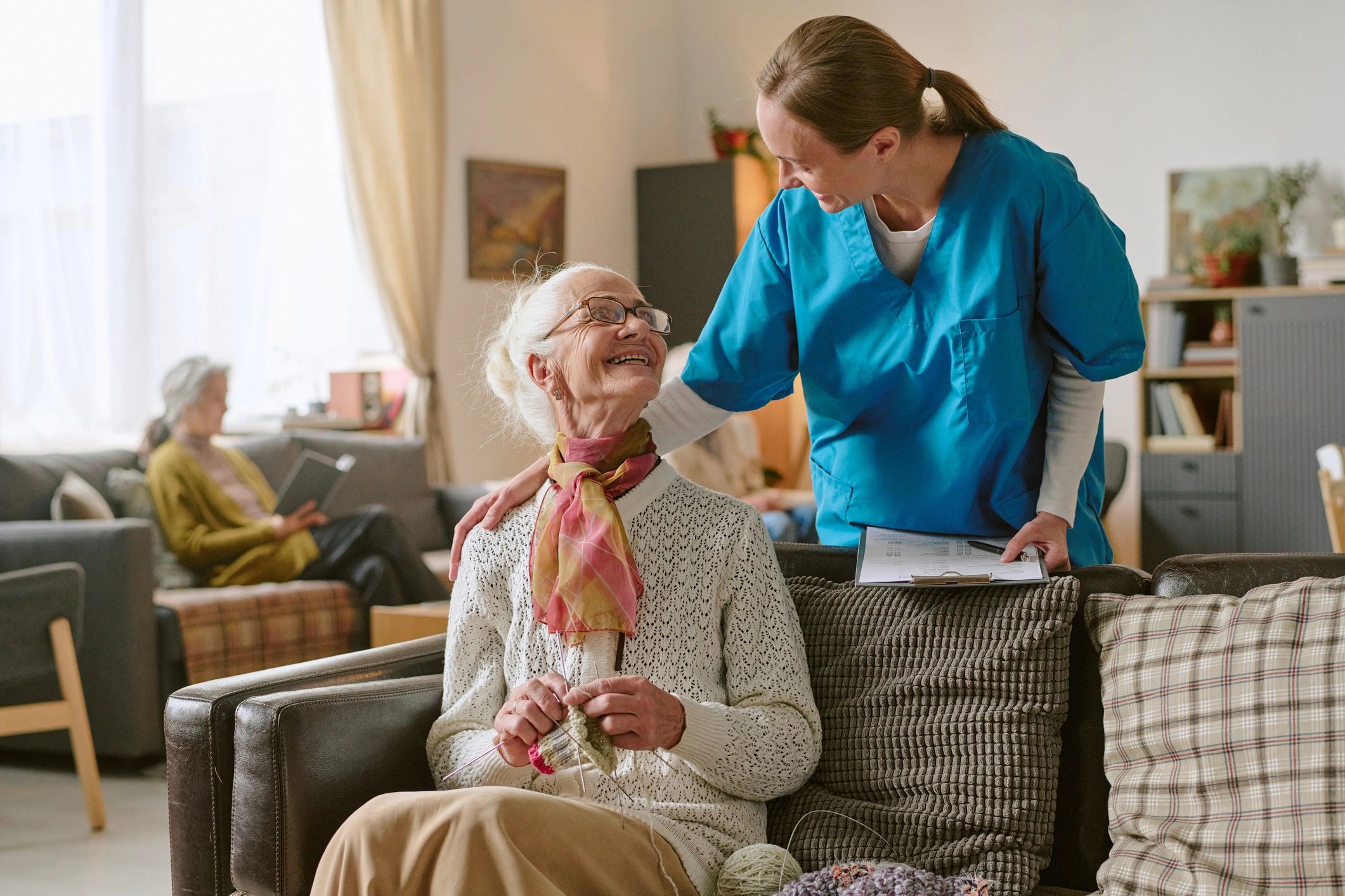 Caregiver smiling with senior client during in-home support visit